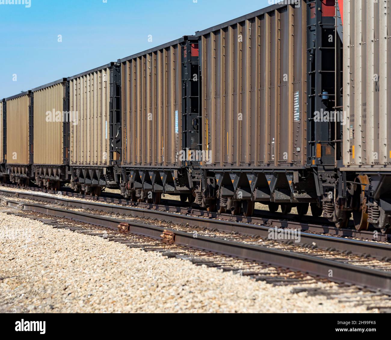Freight train cars on railroad tracks. Supply chain, rail transportation and shipping concept. Stock Photo