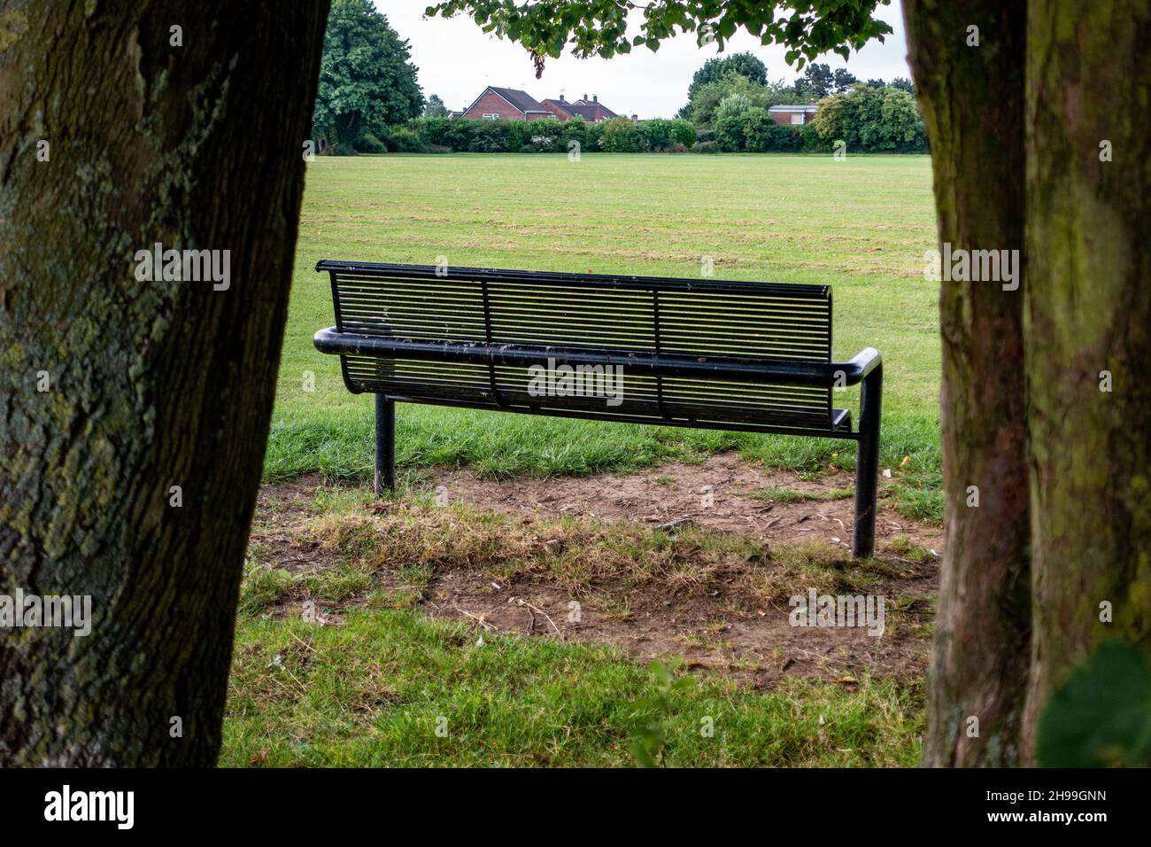 Metal Park bench from the rear in Greenlands Park, Dinnington, South Yorkshire Stock Photo