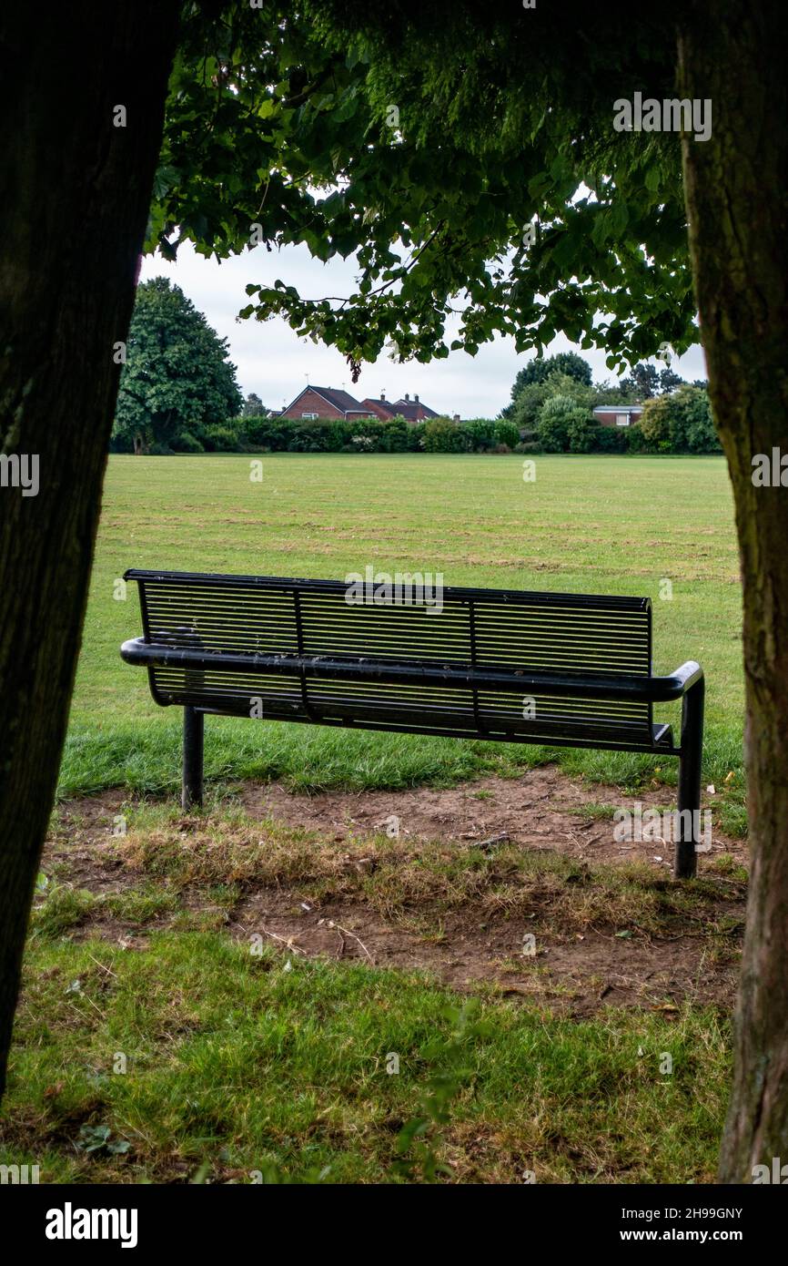 Metal Park bench from the rear in Greenlands Park, Dinnington, South Yorkshire Stock Photo