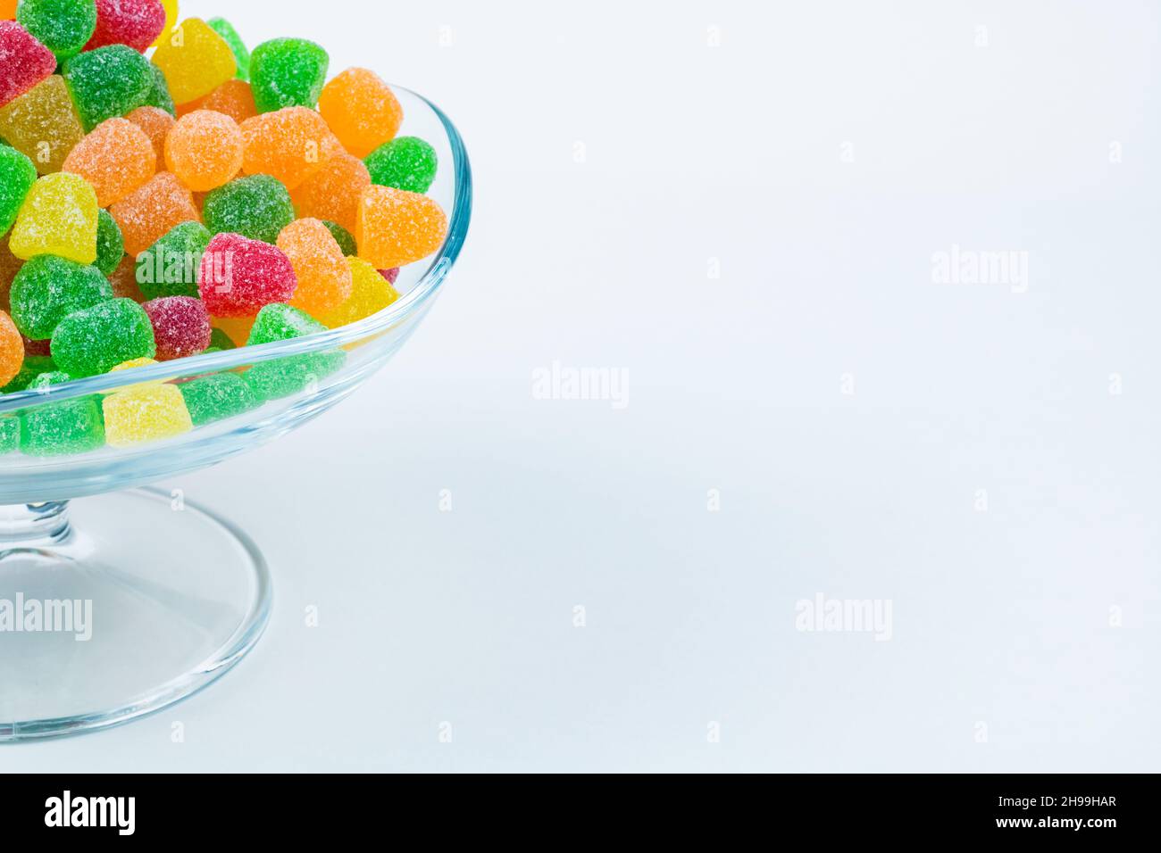 Jelly Candies. Gummy candies in a glass bowl with copy space isolated