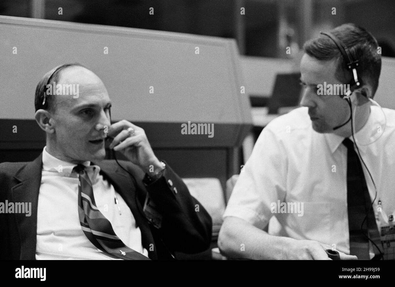 Astronaut Thomas K. (Ken) Mattingly II, who was scheduled as a prime crew member for the Apollo 13 lunar landing mission but was replaced in the final hours when it was discovered he had been exposed to measles, watches the liftoff phase of the mission. He is seated at a console in the Mission Control Center’s (MCC) Mission Operations Control Room (MOCR). Scientist-astronaut Joseph P. Kerwin, a spacecraft communicator for the mission, looks on at right. Stock Photo