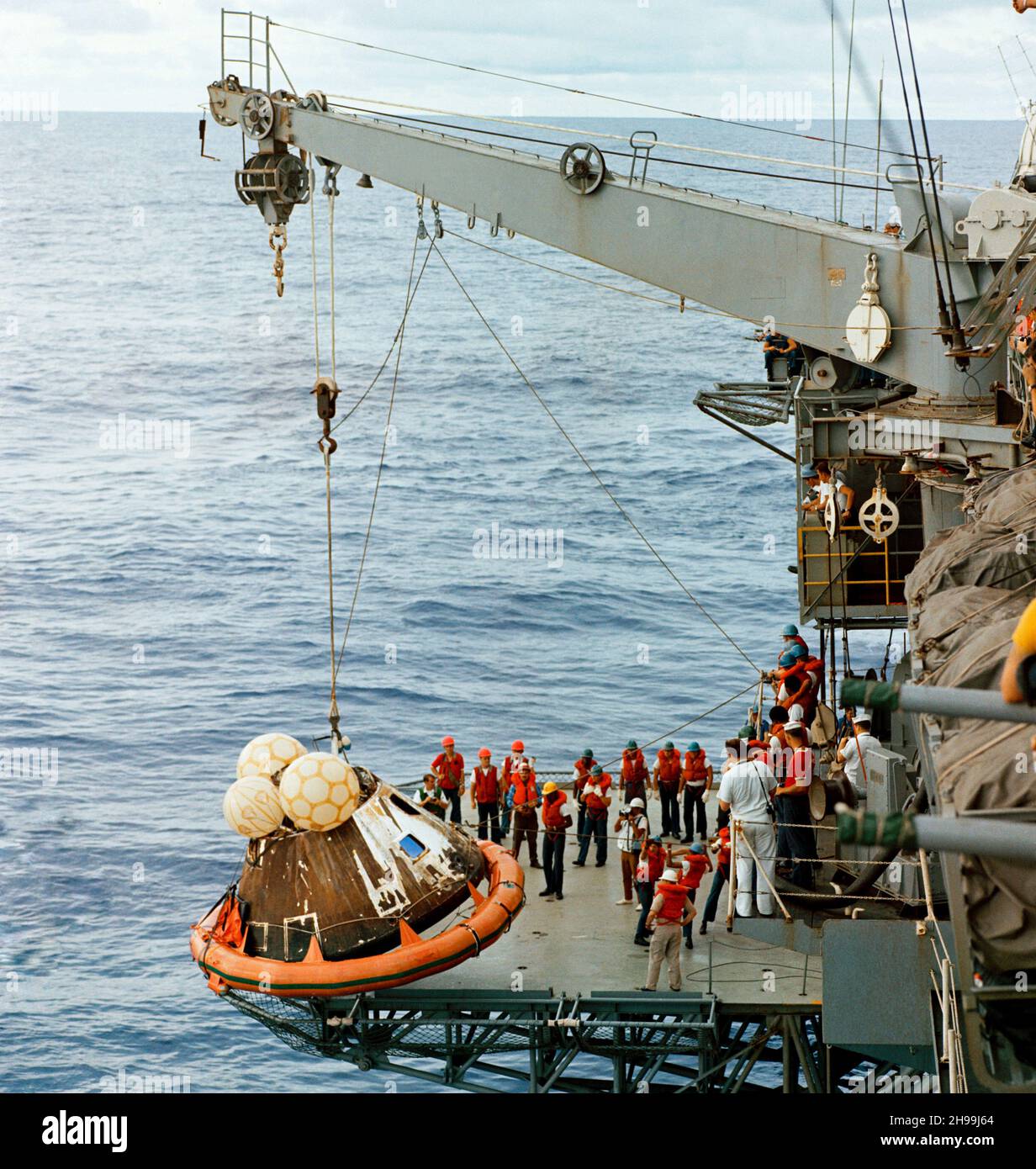 Crew men aboard the USS Iwo Jima, prime recovery ship for the Apollo 13 mission, hoist the Command Module (CM) aboard ship. The Apollo 13 crew men, astronauts James A. Lovell Jr., John L. Swigert Jr. and Fred W. Haise Jr., were already aboard the Iwo Jima when this photograph was taken. The CM, with the three tired crew men aboard, splashed down at 12:07:44 p.m. (CST), April 17, 1970, only about four miles from the recovery vessel in the South Pacific Ocean. Stock Photo