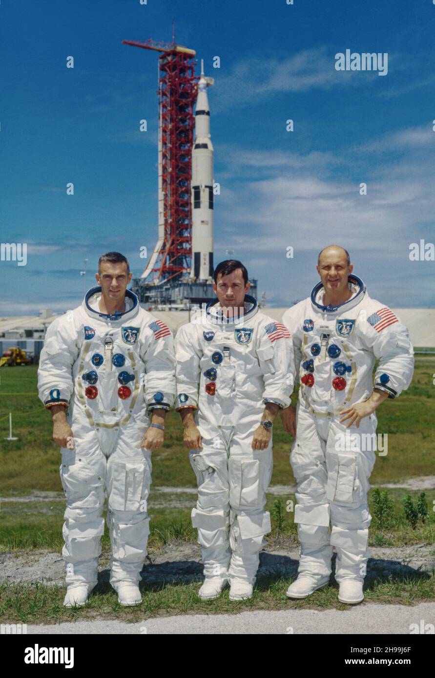 Prime crew of the Apollo 10 lunar orbit mission. Left to right, are Eugene A. Cernan, lunar module pilot; John W. Young, command module pilot; and Thomas P. Stafford, commander. In the background is the Apollo 10 space vehicle on Pad B, Launch Complex 39, Kennedy Space Center, Florida. Stock Photo