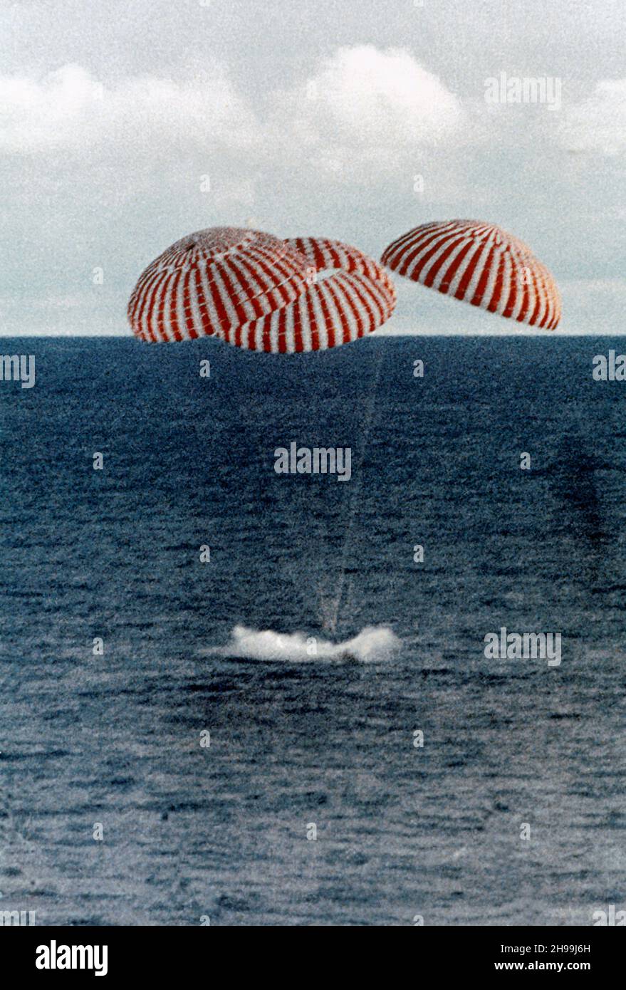 Safe splashdown of the Apollo 13 Command Module (CM) in the South Pacific, only four miles from the prime recovery ship. The spacecraft with astronauts James A. Lovell Jr., John L. Swigert Jr., and Fred W. Haise Jr. aboard, splashed down at 12:07:44 p.m. (CST) April 17, 1970, to conclude safely the problem-plagued flight. The crewmen were transported by helicopter from the immediate recovery area to the USS Iwo Jima, prime recovery vessel. Stock Photo