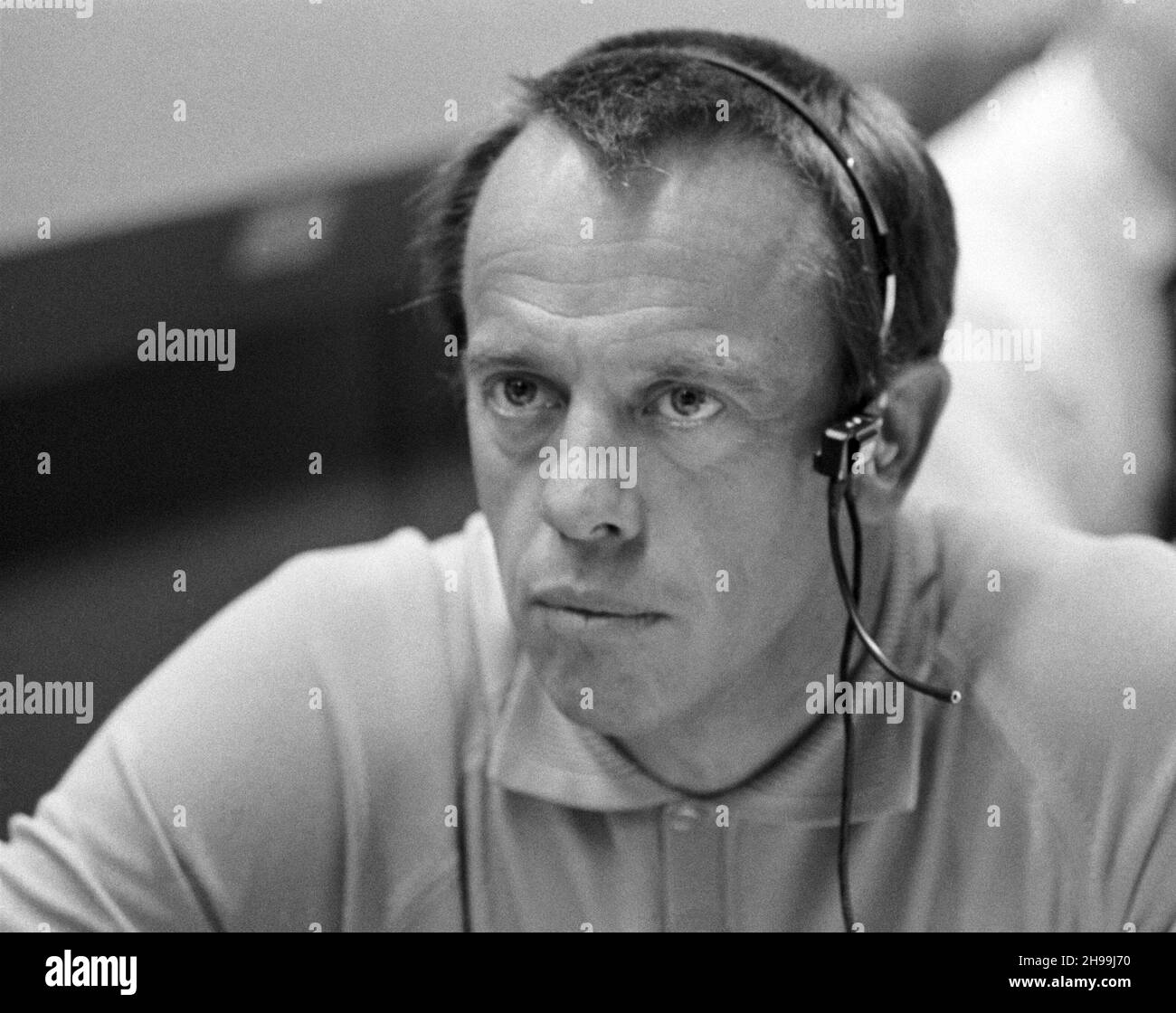 Astronaut Alan B. Shepard Jr., prime crew commander of the Apollo 14 mission, monitors communications between the Apollo 13 spacecraft and Mission Control Center. He is seated at a console in the Mission Operations Control Room of the MCC, Manned Spacecraft Center. The main concern of the moment was action taken by the three Apollo 13 crewmen - astronauts James A. Lovell Jr., John L. Swigert Jr. and Fred W. Haise Jr. - to make corrections inside the spacecraft following discovery of an oxygen cell failure several hours earlier. Stock Photo