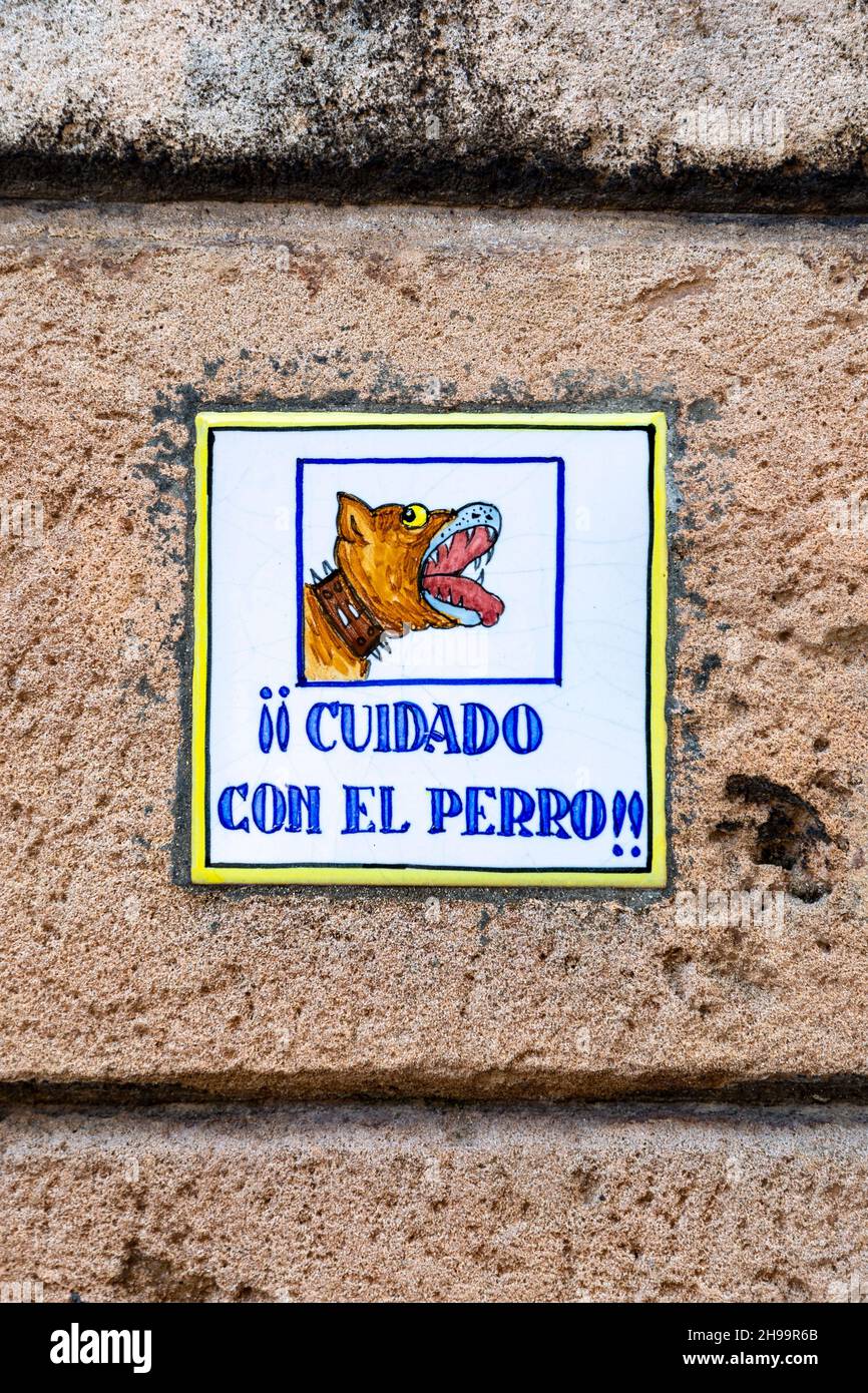 'Cuidado Con El Perro' (Beware of the Dog) plaque on a house in the quiet neighbourhood of La Bonanova, Mallorca, Spain Stock Photo