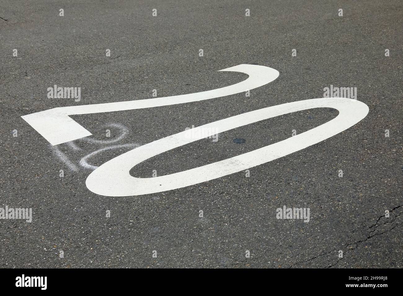 A speed limit of 20 kilometers per hour is visible on the road surface. Stock Photo