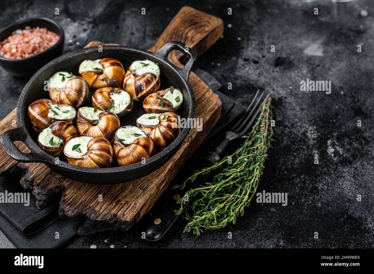Delicatessen food Bourgogne Escargot Snails with garlic butter in a