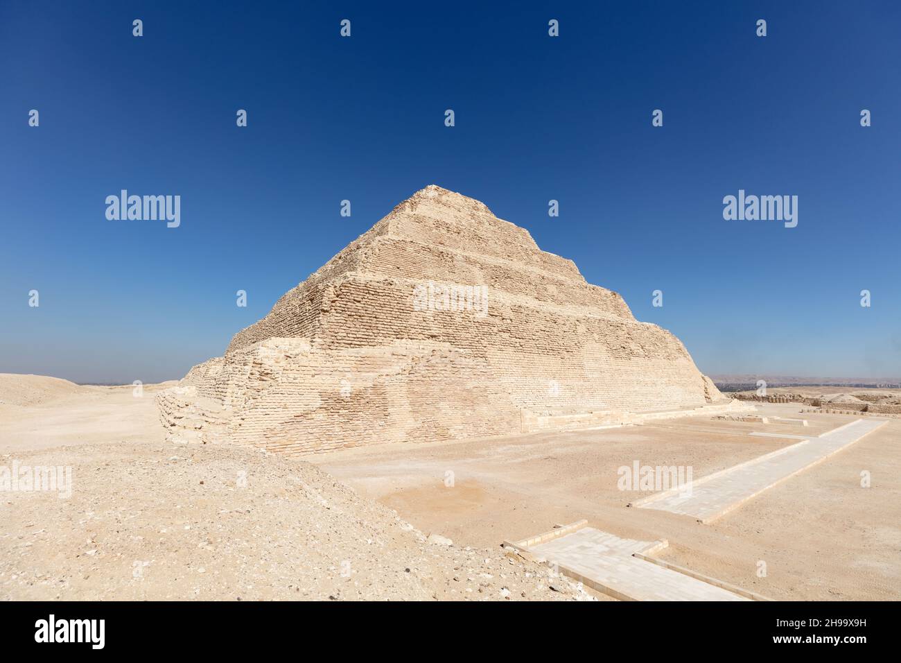 Unique white egyptian pyramid with the blue sky on the background. Stock Photo