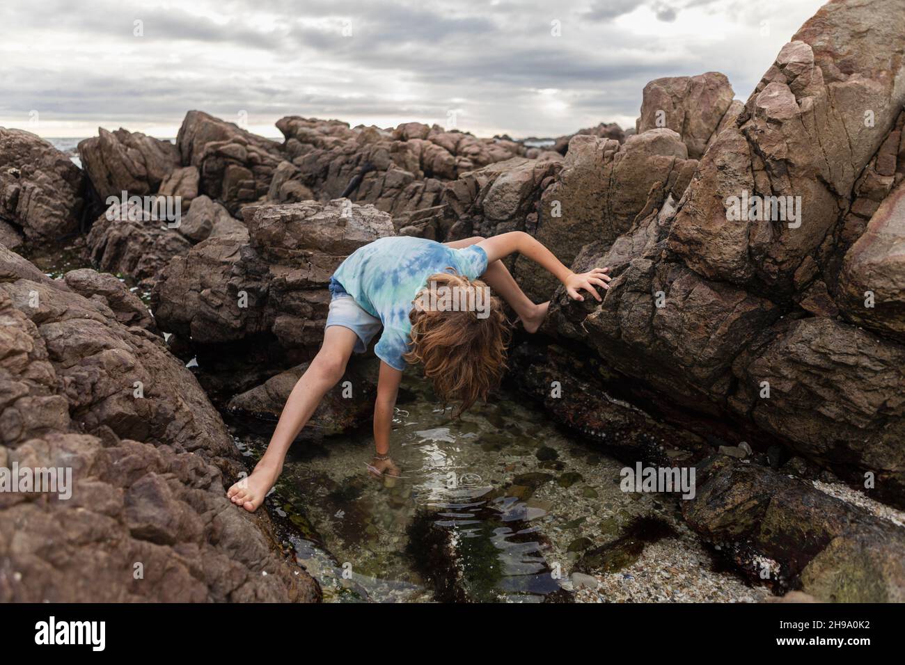 Young boy exploring tidal pool, De Kelders, Western Cape, South Africa. Stock Photo