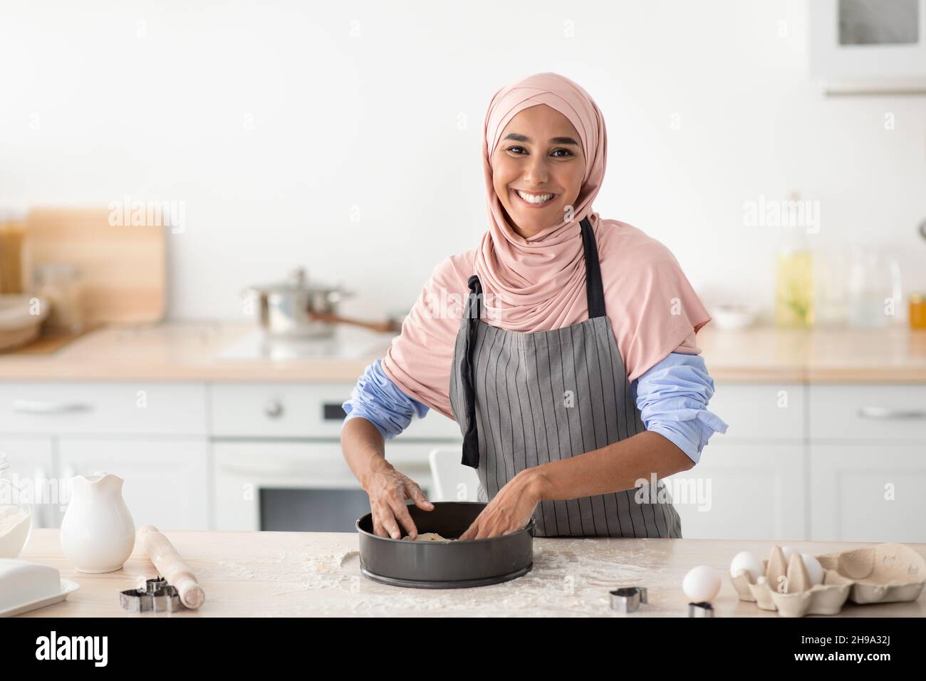 Happy Muslim Woman Pressing Dough Into Mold While Baking In Kitchen ...