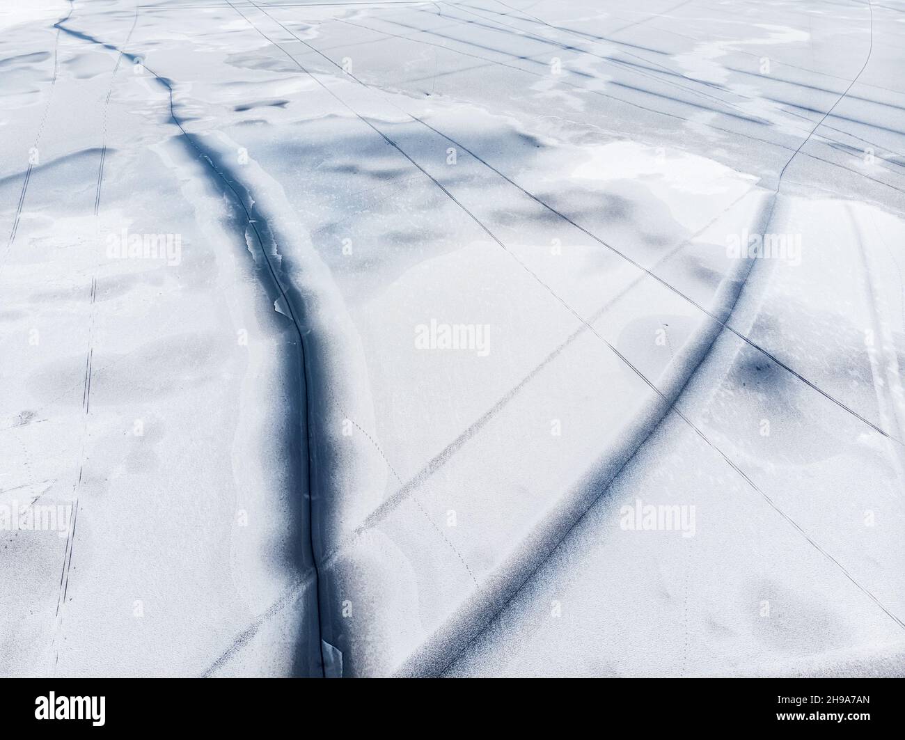 Flying above frozen lake cracked hi-res stock photography and images ...