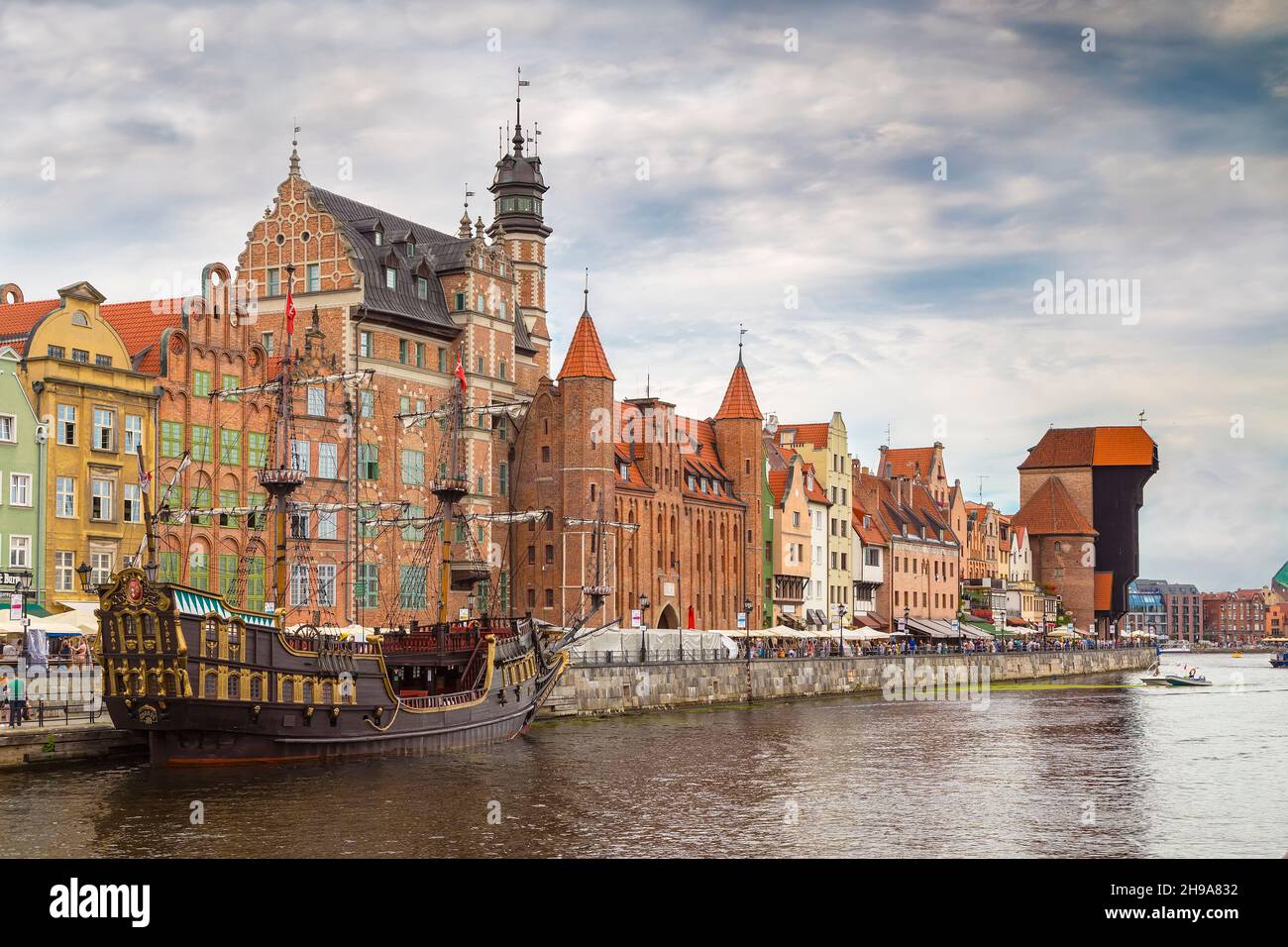 GDANSK, POLAND - AUGUST 02, 2017: Embankment of the river with pleasure boats and yachts, an excursion pirate ship and the construction of the XV cent Stock Photo