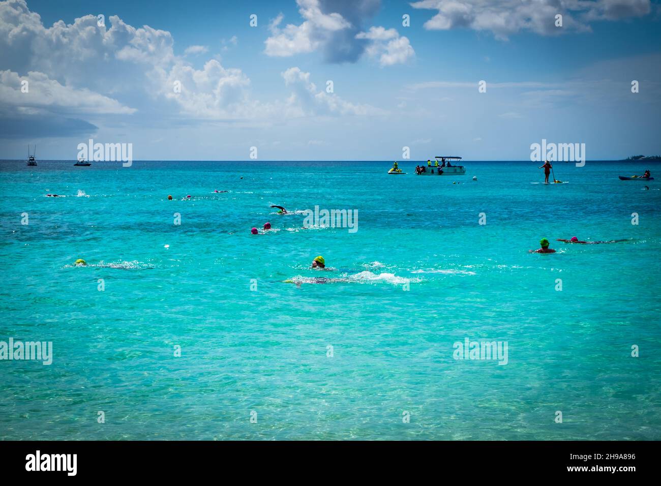 Swimmers in the Caribbean Sea during a competition by Seven Mile Beach, Grand Cayman, Cayman Islands Stock Photo