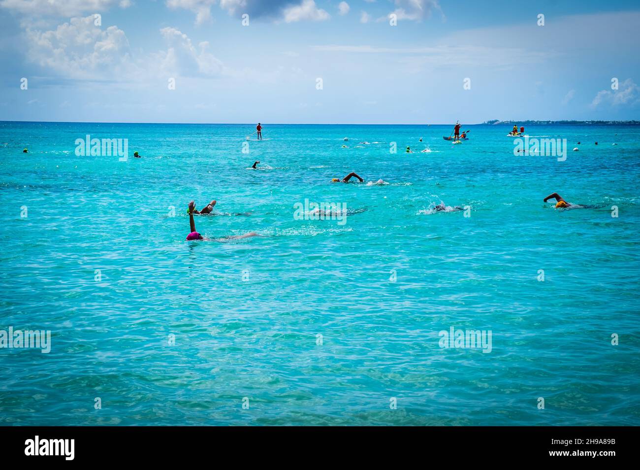 Swimmers in the Caribbean Sea during a competition by Seven Mile Beach, Grand Cayman, Cayman Islands Stock Photo