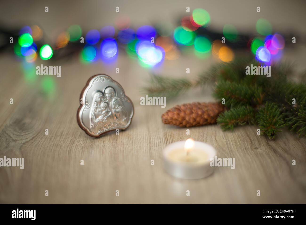Christmas Composition of Church Icon on a Wooden Background With colorful Light Stock Photo