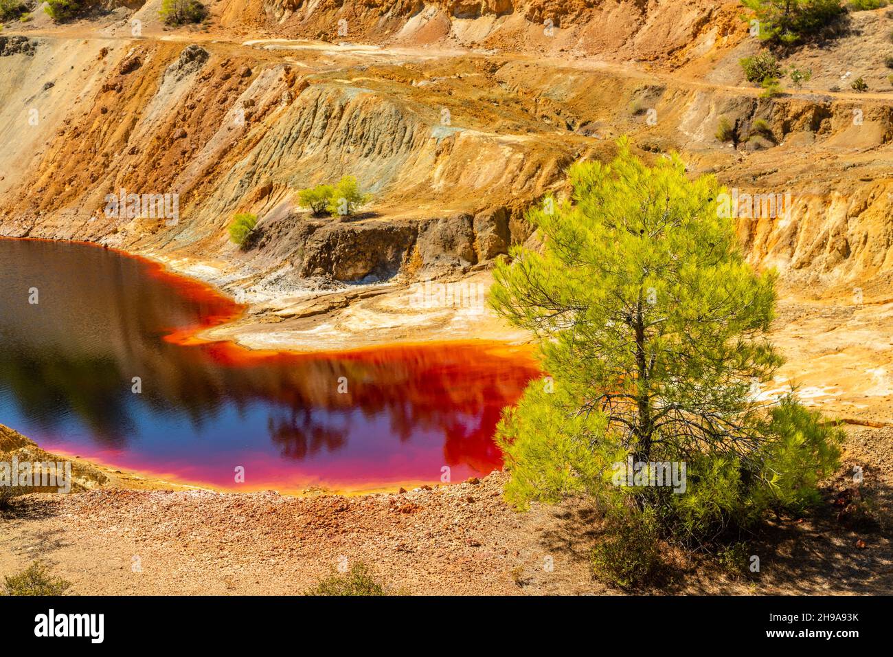 Dangerous bloody colored with copper pollution Sha mine lake, Nicosia, Cyprus Stock Photo