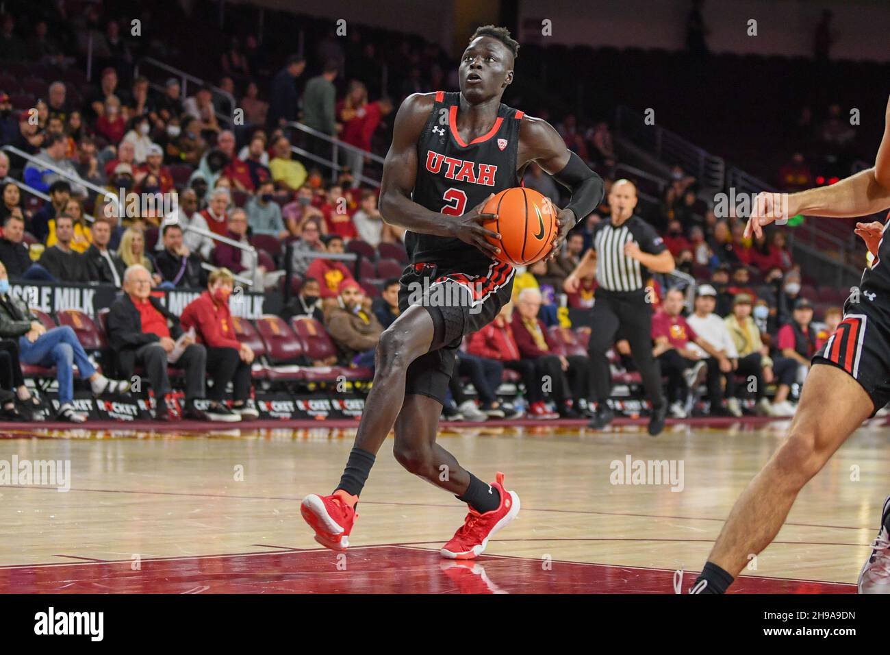 Utah Utes guard Both Gach (2) goes up to dunk the ball during an NCAA basketball game against the Southern California Trojans, Wednesday, Dec. 1, 2021 Stock Photo