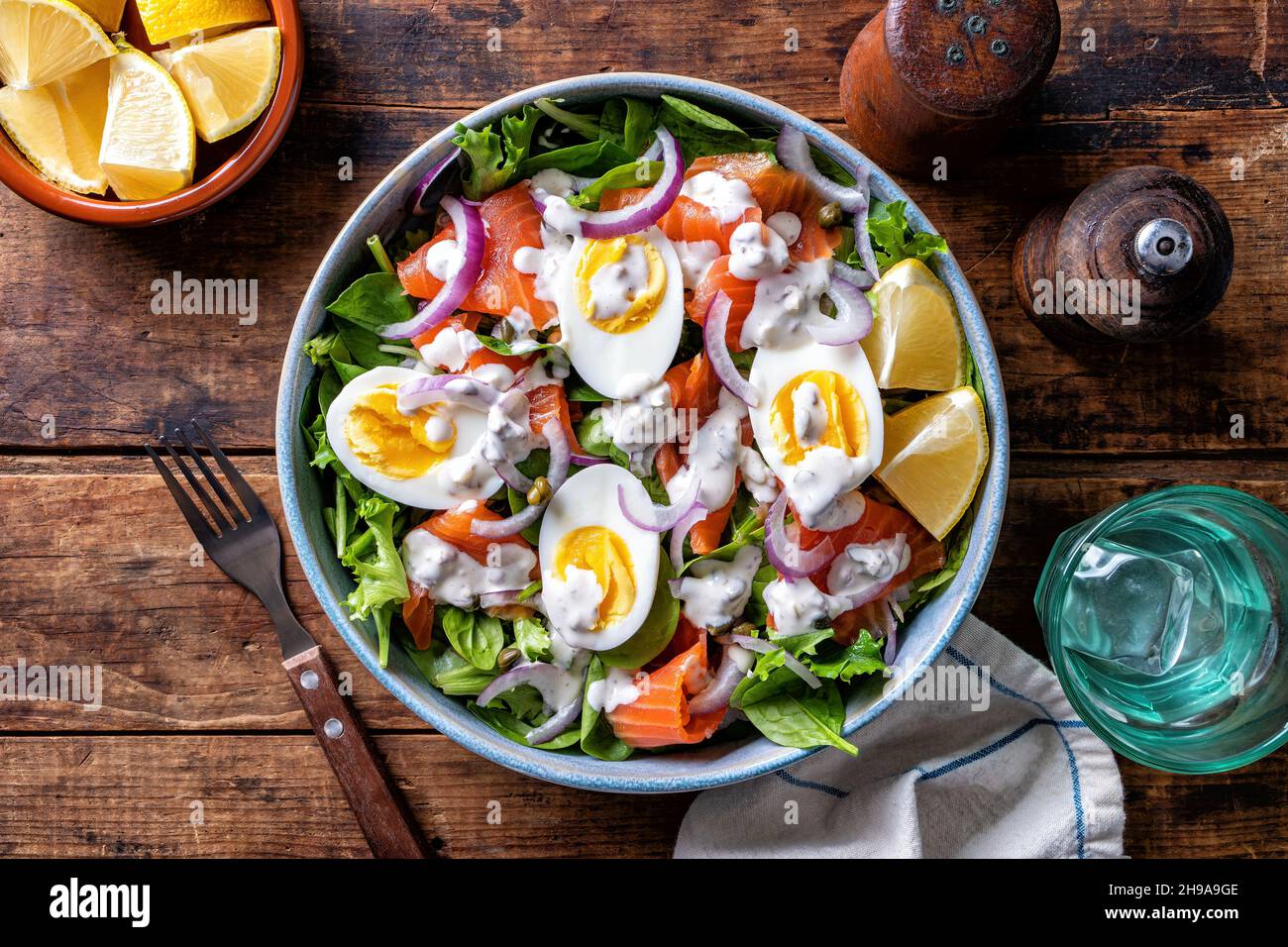 A delcious smoked salmon salad with eggs and anchovy caper dressing. Stock Photo