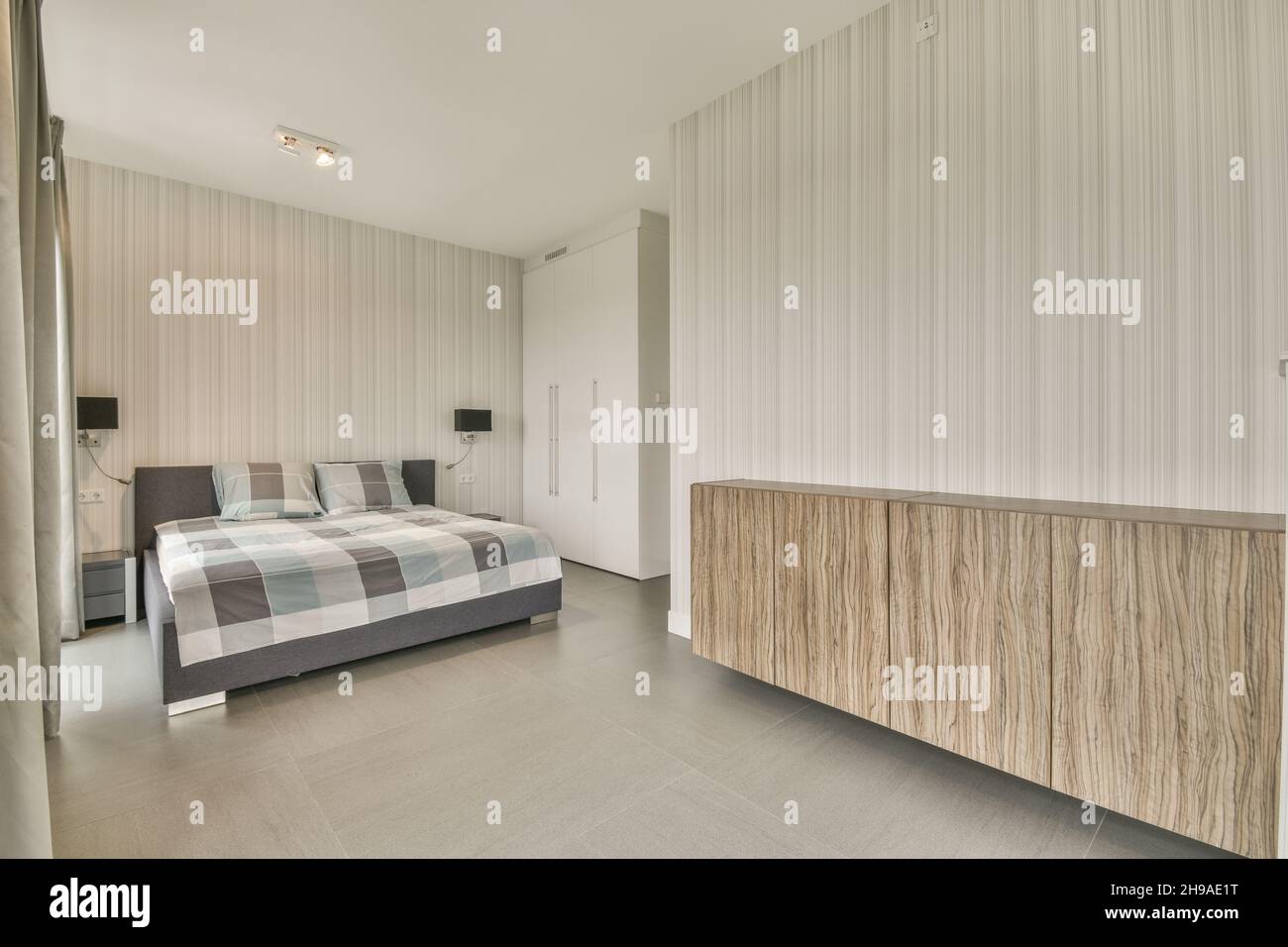 Stylish interior of contemporary bedroom with comfortable furniture