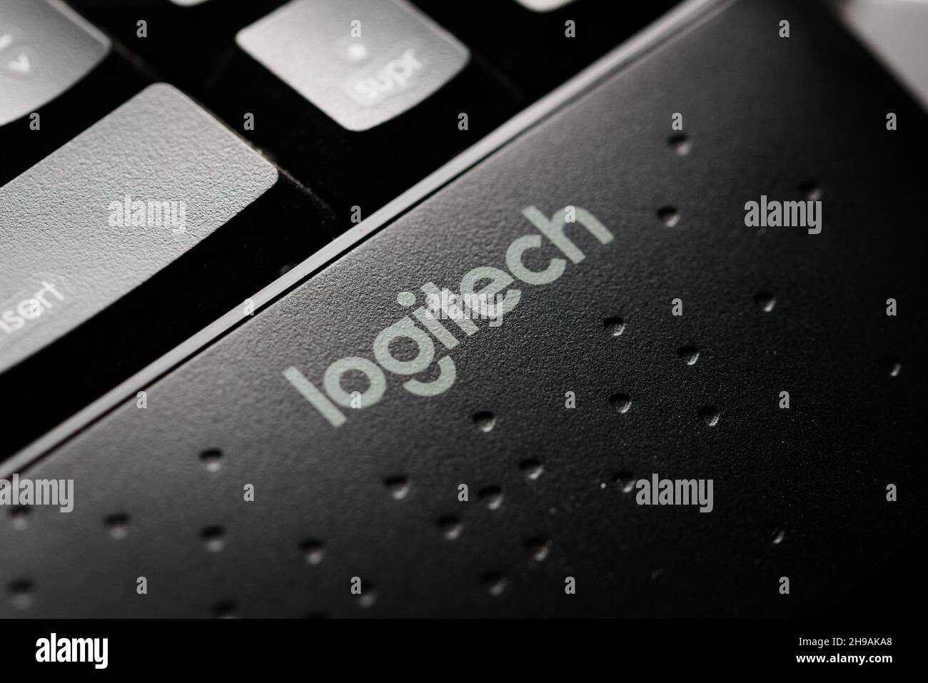 Logitech company brand logo in a modern black keyboard. Macro close up detail. Stock Photo