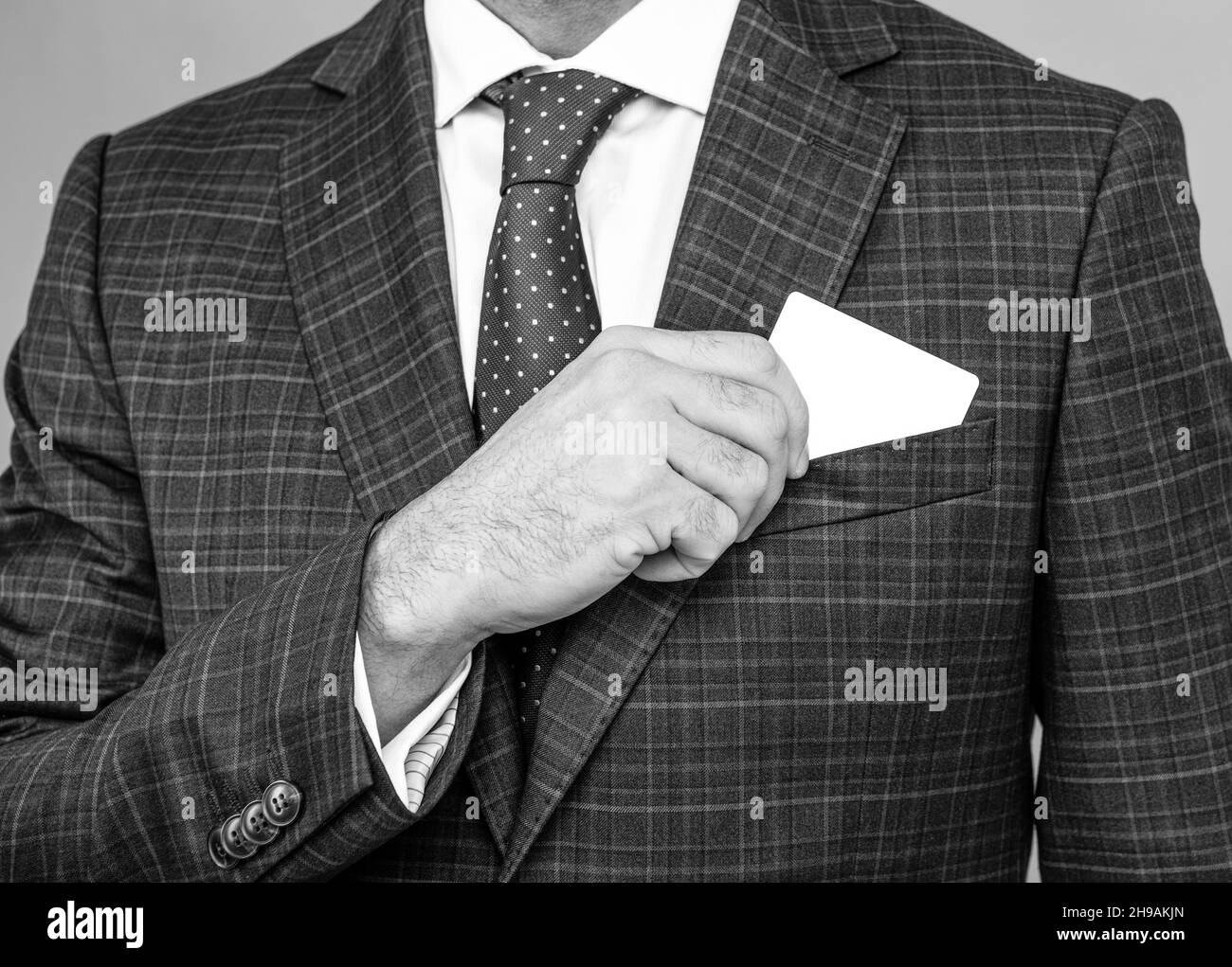 Presenting his visiting card. Male hand pull visiting card out of pocket. Business information Stock Photo