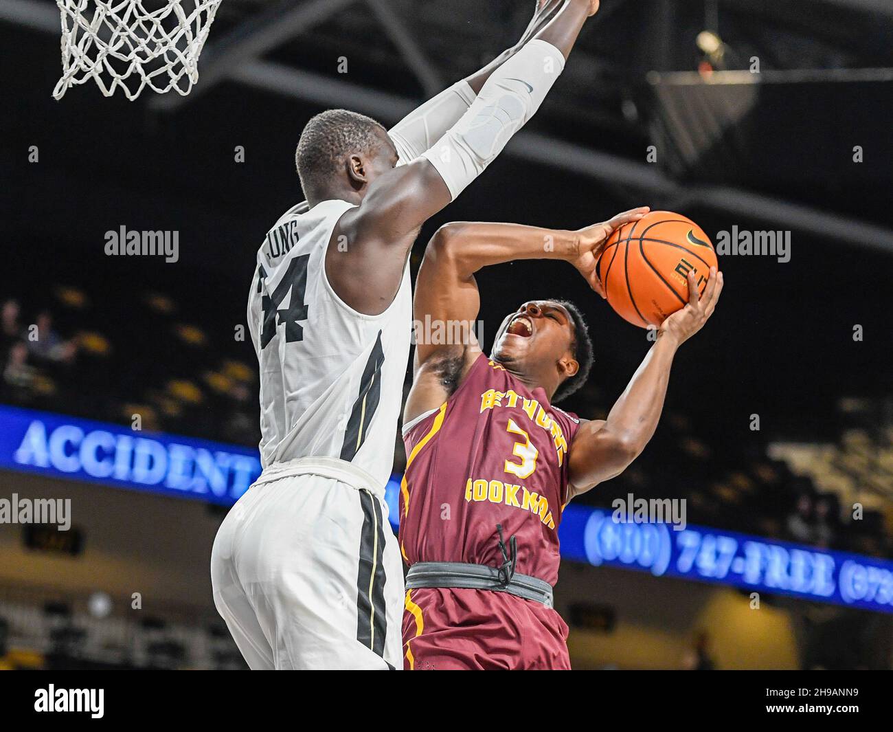 Orlando, FL, USA. 5th Dec, 2021. UCF Knights forward Cheikh Mbacke Diong  (34) defends a shot under the basket by Bethune-Cookman Wildcats guard  Marcus Garrett (3) during 1st half mens NCAA basketball