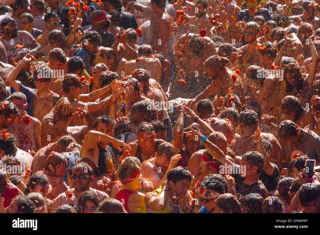 People throwing tomatoes at La Tomatina (Tomato Festival), Bunol, Valencia Province, Spain Stock Photo