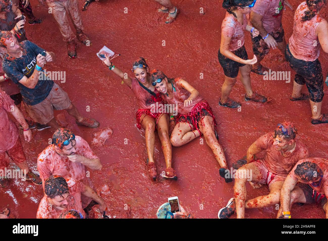 People throwing tomatoes at La Tomatina (Tomato Festival), Bunol, Valencia Province, Spain Stock Photo