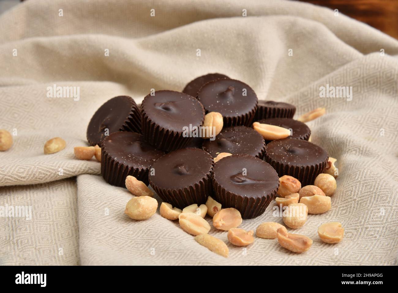 A mound of dark chocolate peanut butter cups with salted peanuts Stock Photo