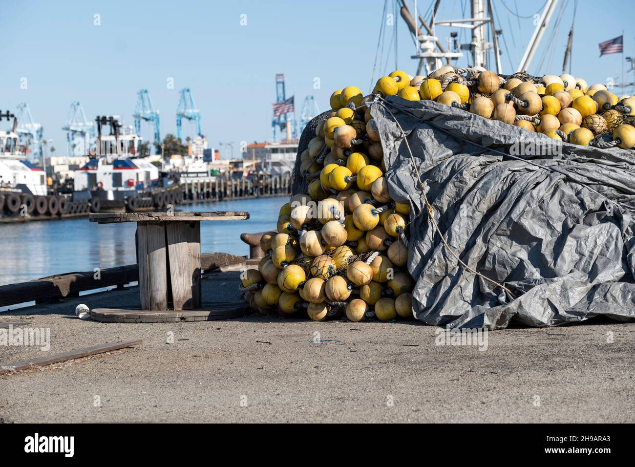 Large commercial fishing net with buoys on a dock in the harbor Stock