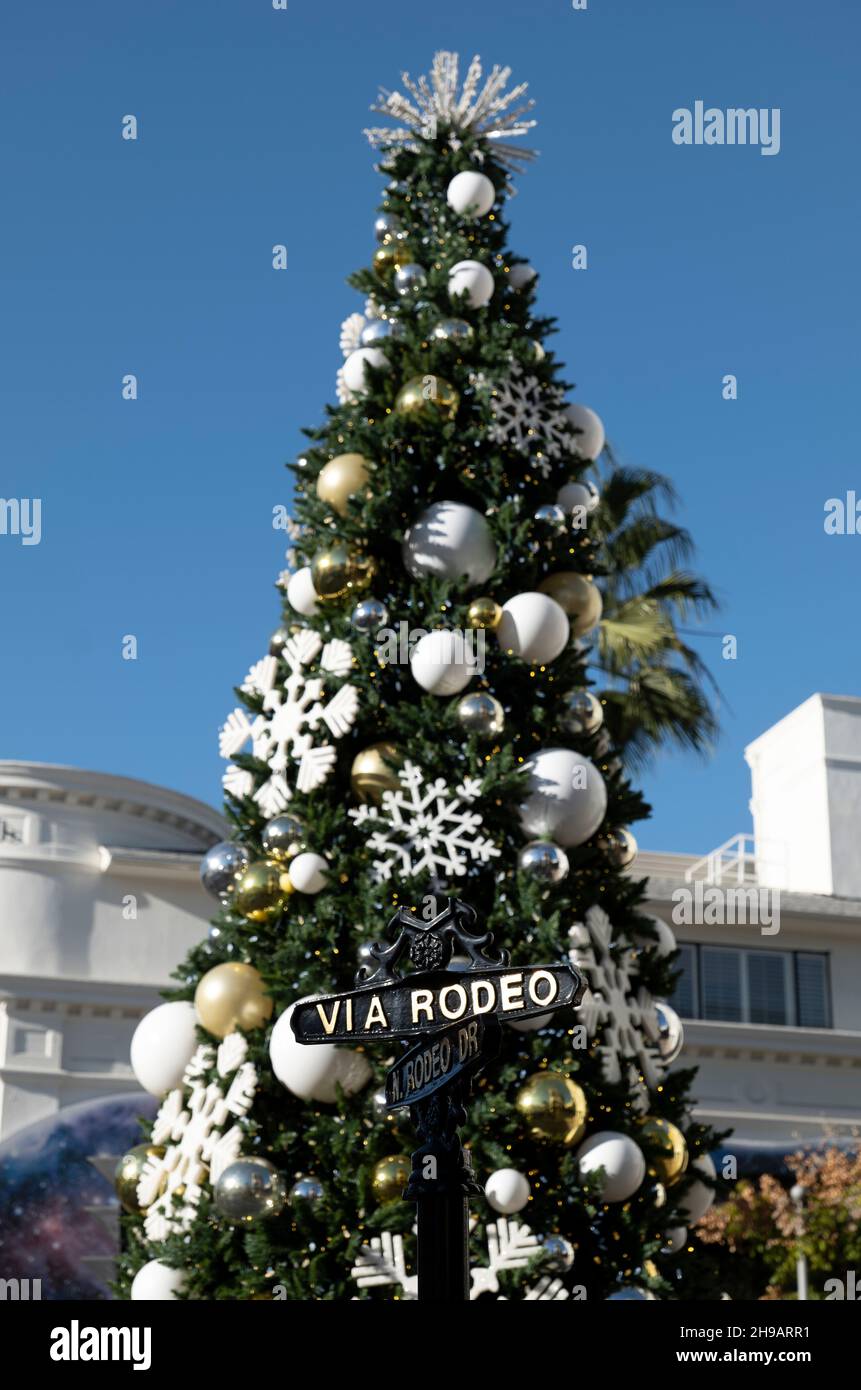 Beverly Hills, CA USA - November 25, 2021: Christmas tree on Rodeo Drive behind the street sign Stock Photo
