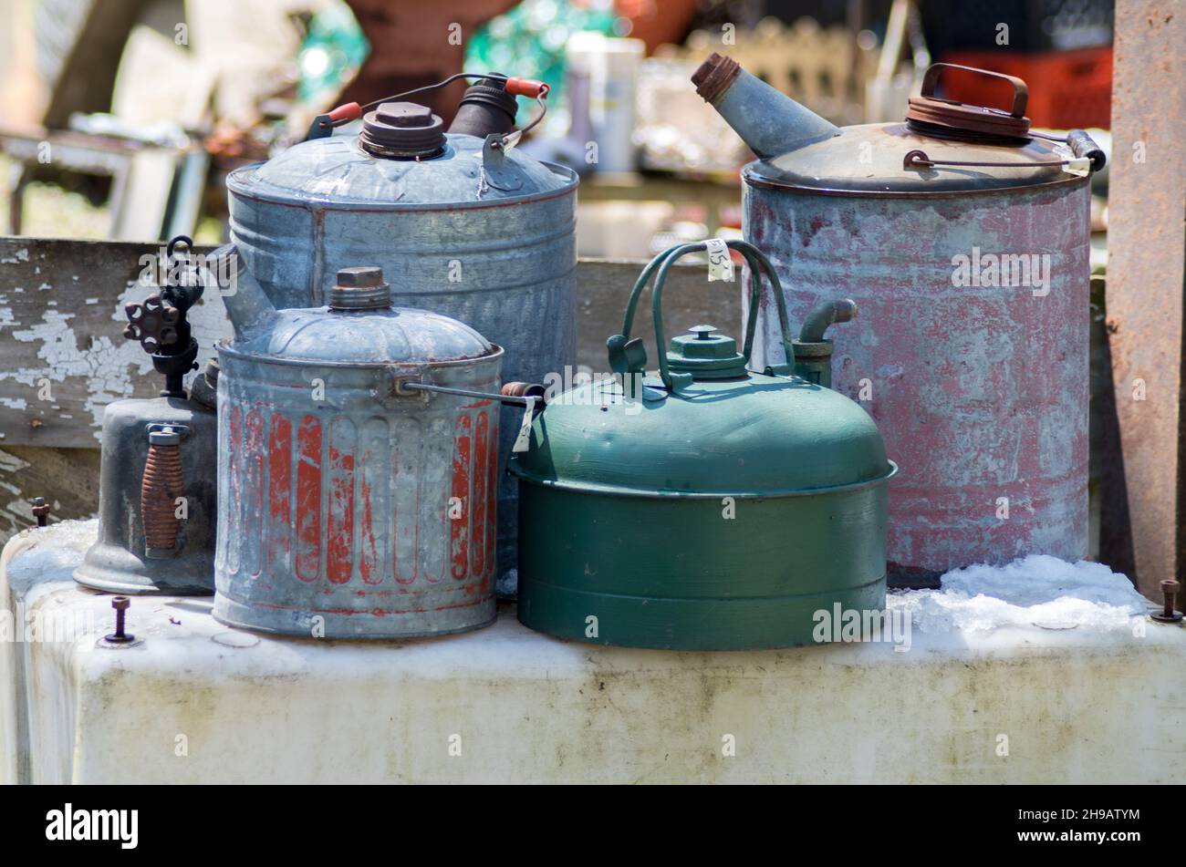 Antique gas cans, or petrol cans are for sale at a outdoor antique sale ...