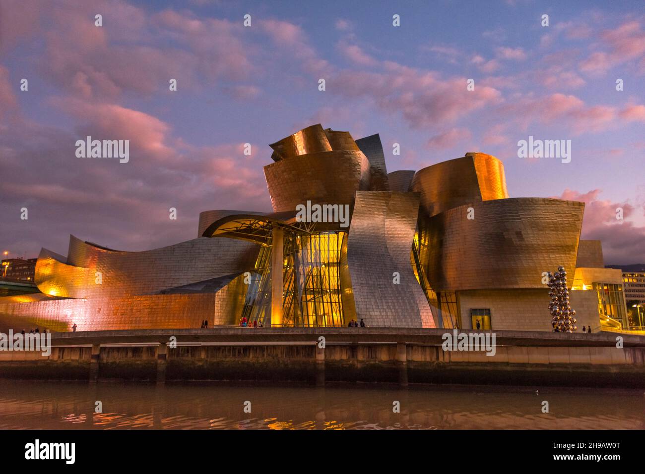 Night view of Guggenheim Museum Bilbao by Nervion River, Bilbao, Biscay Province, Basque County Autonomous Community, Spain Stock Photo