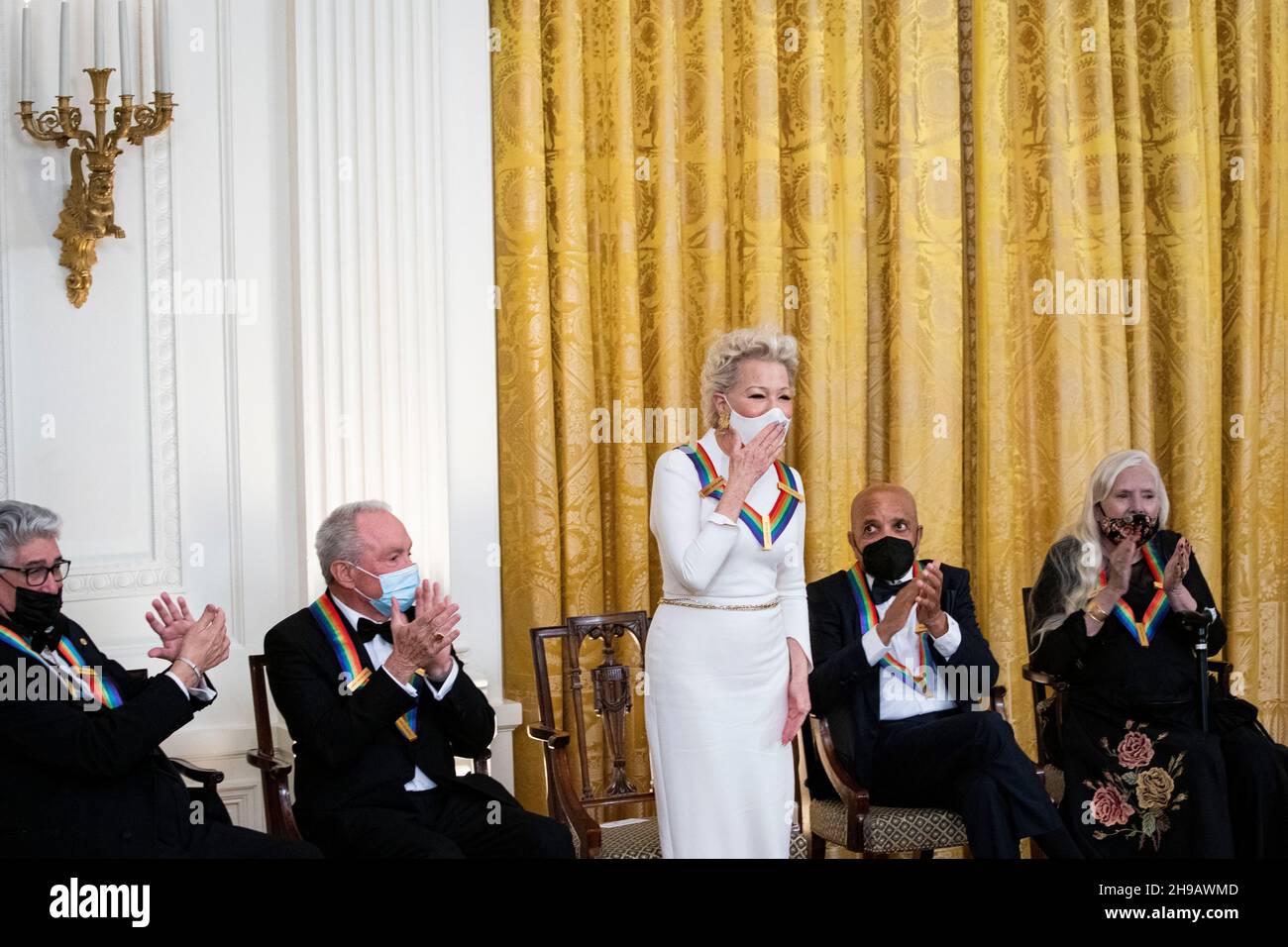 Washington, DC, U.S., on Sunday, Dec. 5, 2021. Actress Bette Midler stands while being recognized by U.S. President Joe Biden, not pictured, during the Kennedy Center Honorees Reception in the East Room of the White House in Washington, DC, U.S., on Sunday, Dec. 5, 2021. The John F. Kennedy Center for the Performing Arts 44th Honorees for lifetime artistic achievements include operatic bass-baritone Justino Diaz, Motown founder Berry Gordy, Saturday Night Live creator Lorne Michaels, actress Bette Midler, and singer-songwriter Joni Mitchell.Credit: Al Drago/Pool via CNP /MediaPunch Stock Photo