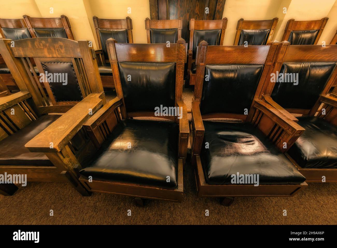 Classic leather and oak jury chairs in jury box of a courtroom of the