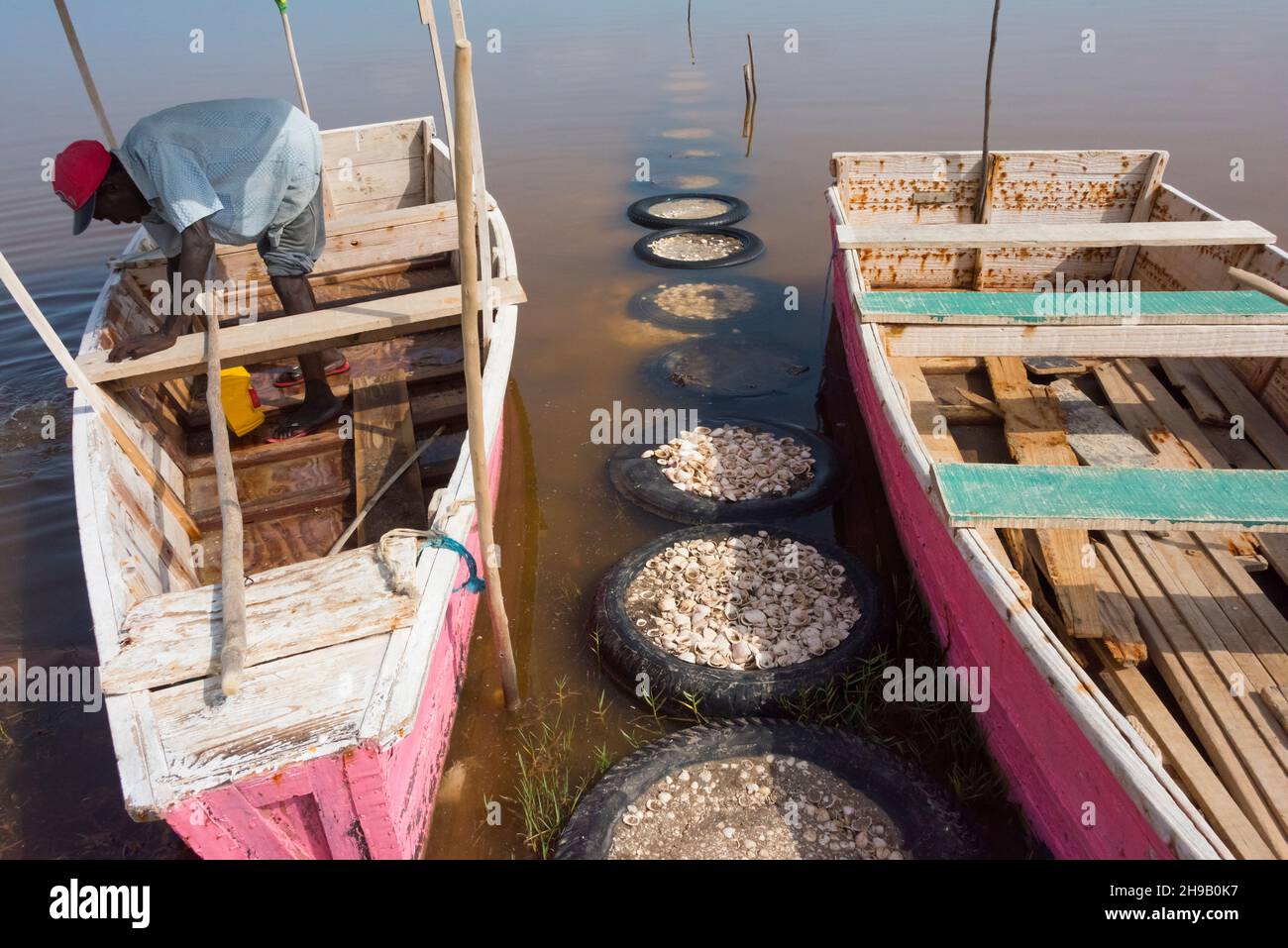 Boats on the shore of Lake Retba (Pink Lake), UNESCO World Heritage site, Cap Vert peninsula, Senegal Stock Photo