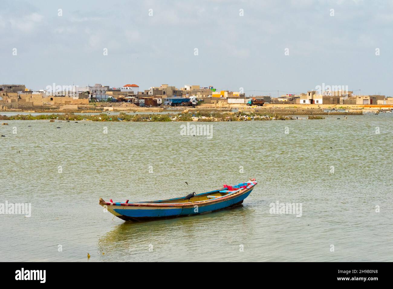 Boat and houses along Senegal River, Saint-Louis, Senegal Stock Photo