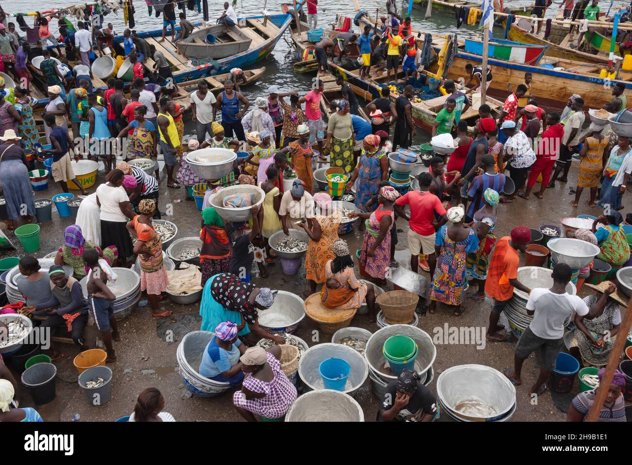 People waiting for the fishing boats to come into the harbor, Elmina, Central Region, Ghana Stock Photo