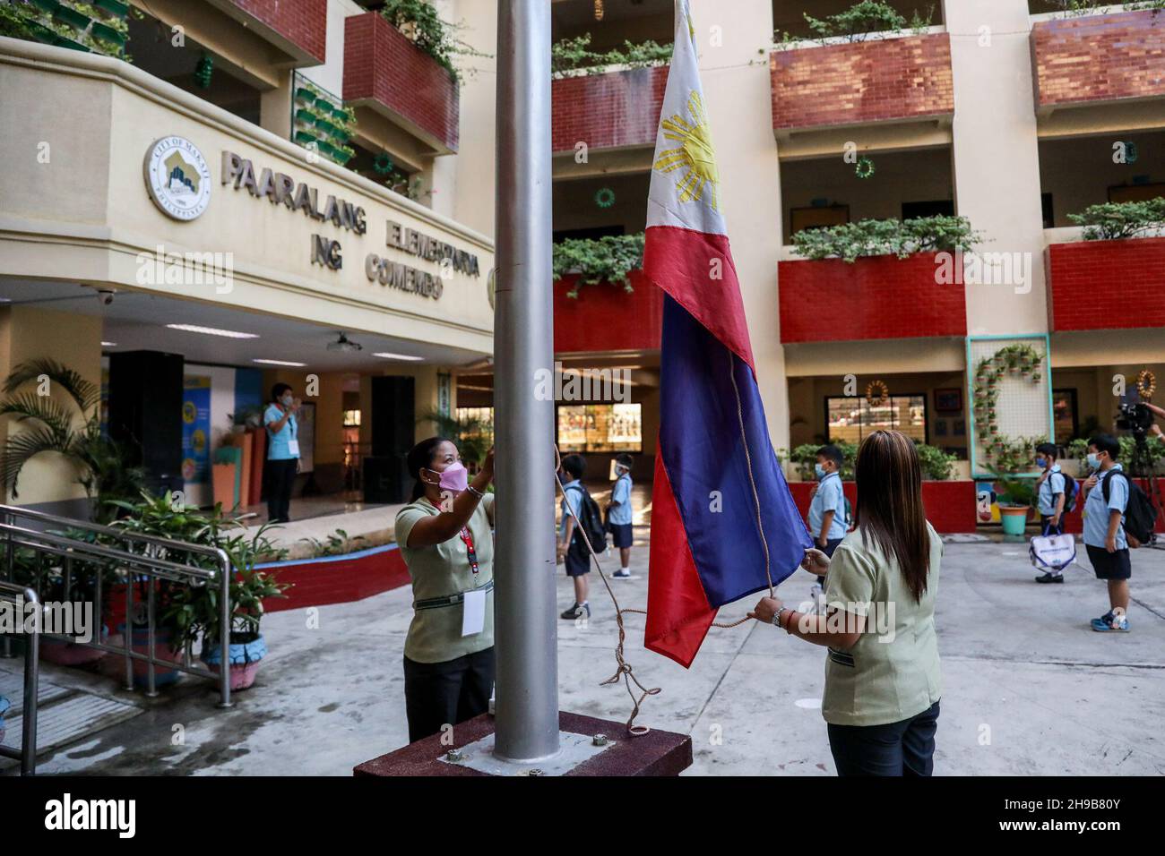 December 6, 2021 Teachers hoist the Philippine flag during a flag