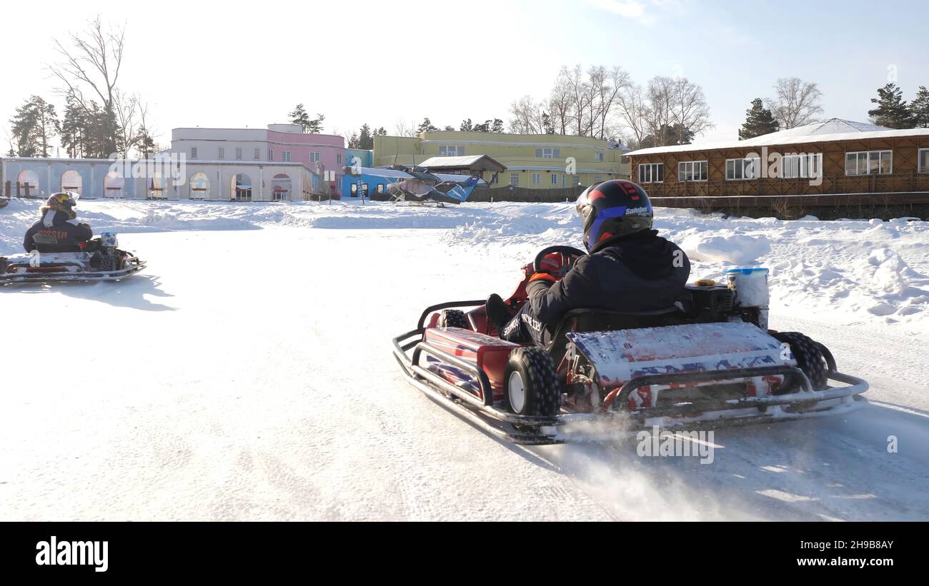 Winter competitions of kart racing on the ice of road. Go kart in ...