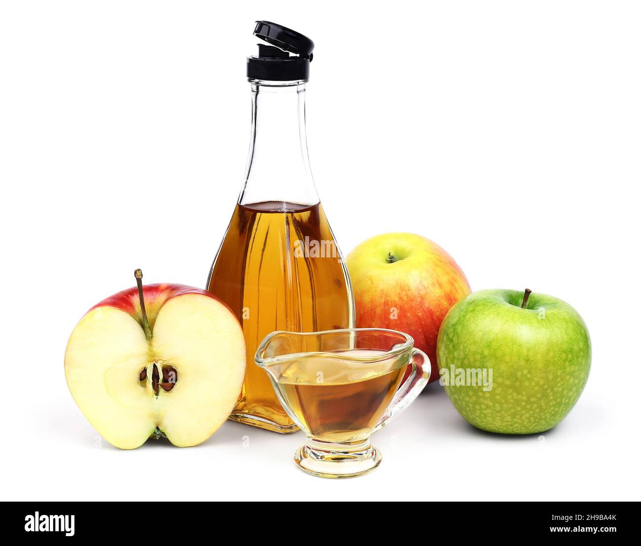 The open transparent full bottle and cup of Apple cider vinegar and a