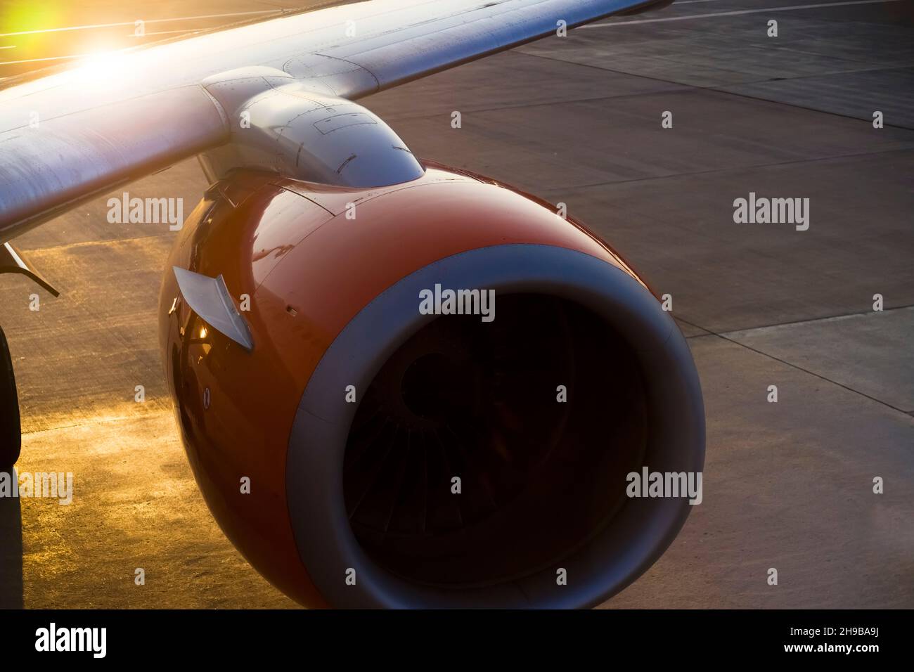 Airplane at sunset on the runway Stock Photo - Alamy
