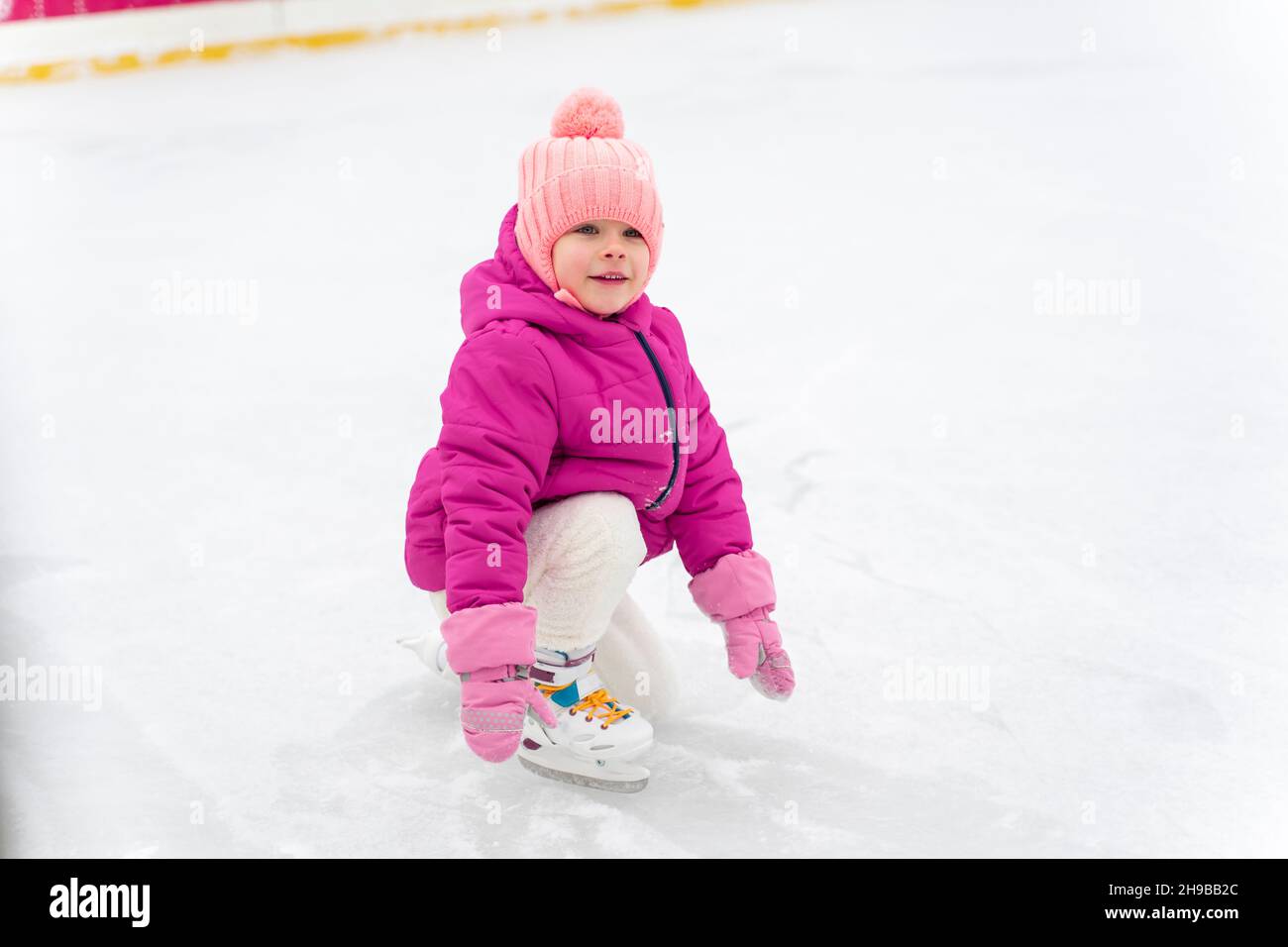 happy little girl ice skating on the ice rink Stock Photo Alamy