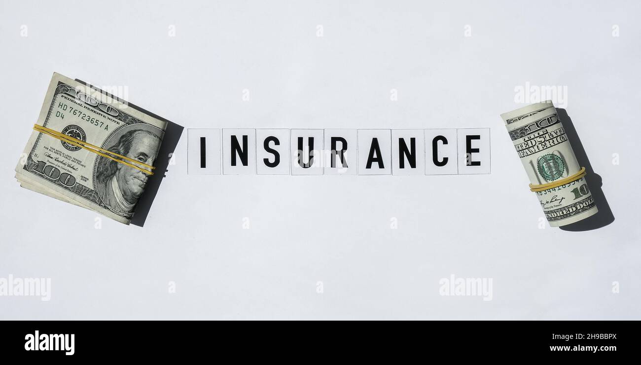 Text INSURANCE around US dollar banknotes. Health, life, home, car ...
