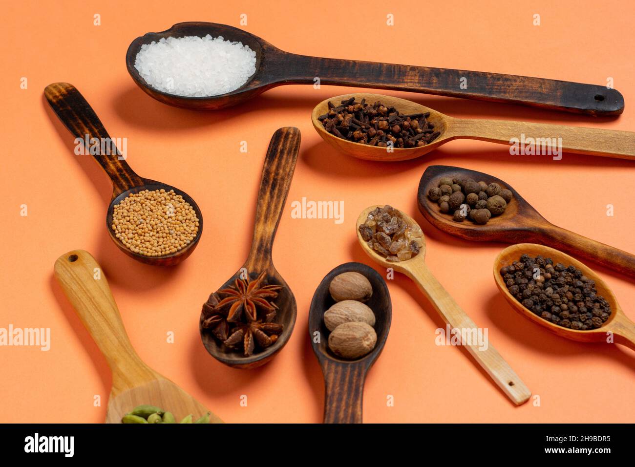 Different spices in spoons colorful background. Flat lay or top view. Stock Photo