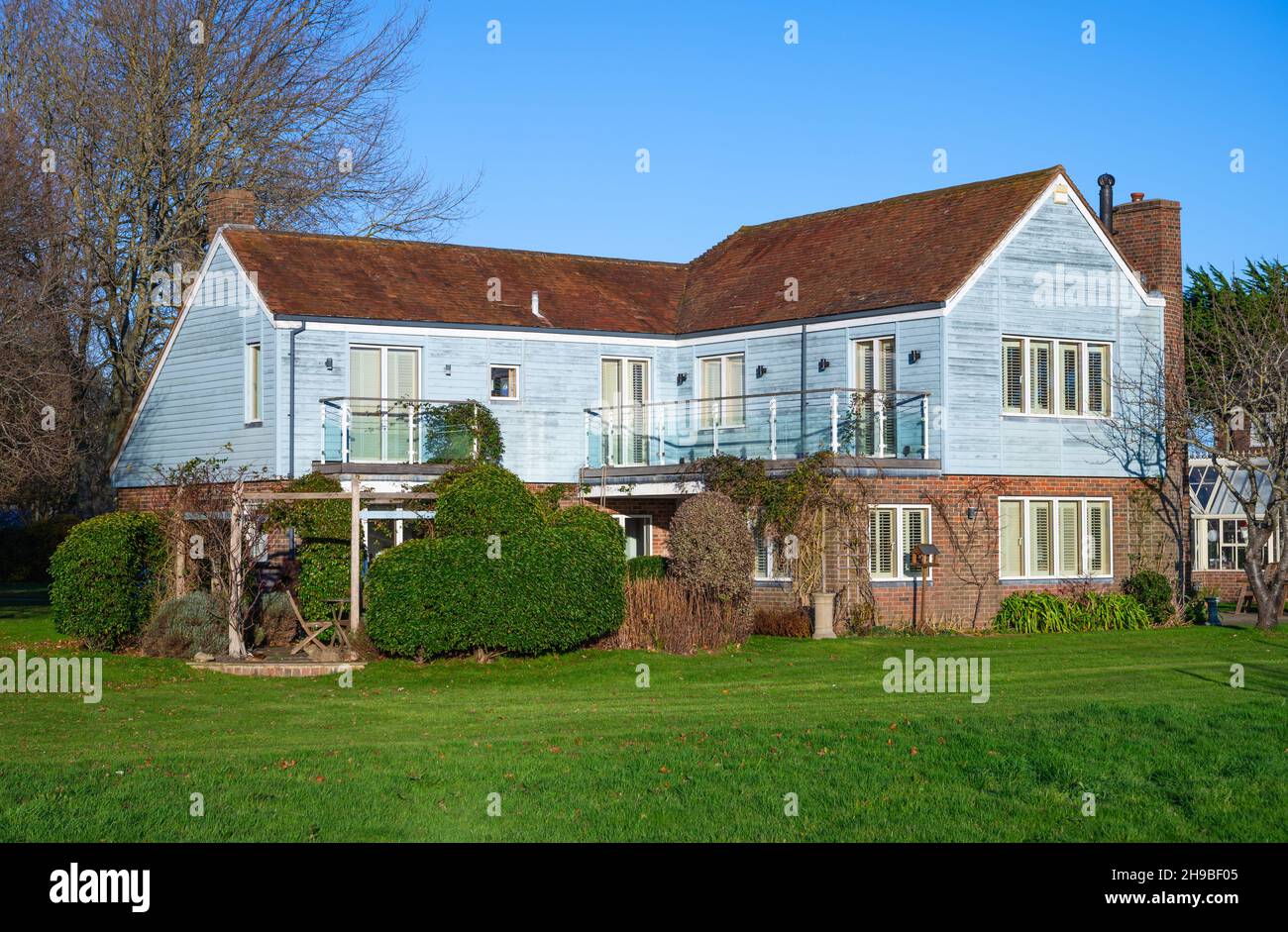 Meadow House on Canute Road (view shown is from Shore Road), a waterfront property with large front garden in Bosham Village, West Sussex, England, UK Stock Photo