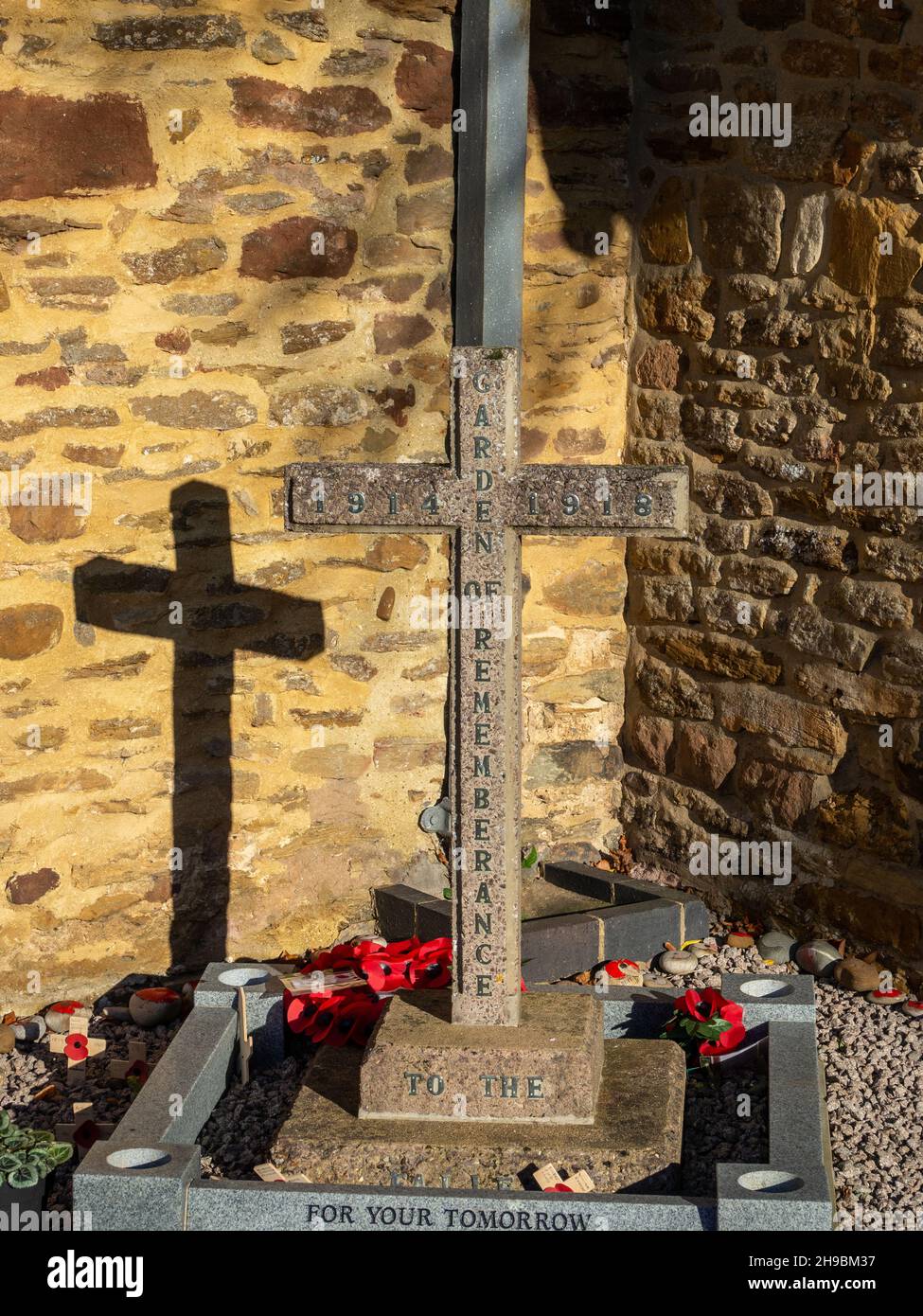 Wooden cross of sacrifice with shadow, memorial to the fallen of WW1, St Faith church, Kilsby, Northamptonshire, UK Stock Photo