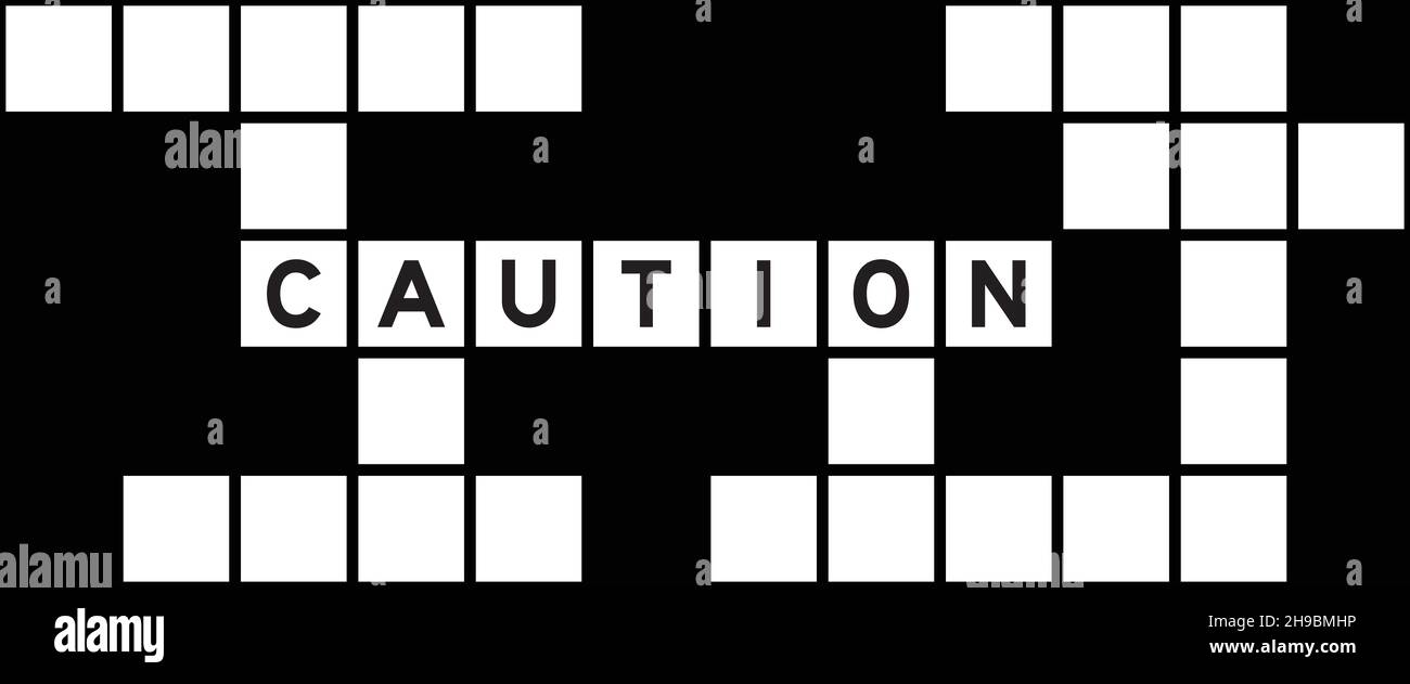 Alphabet letter in word caution on crossword puzzle background Stock