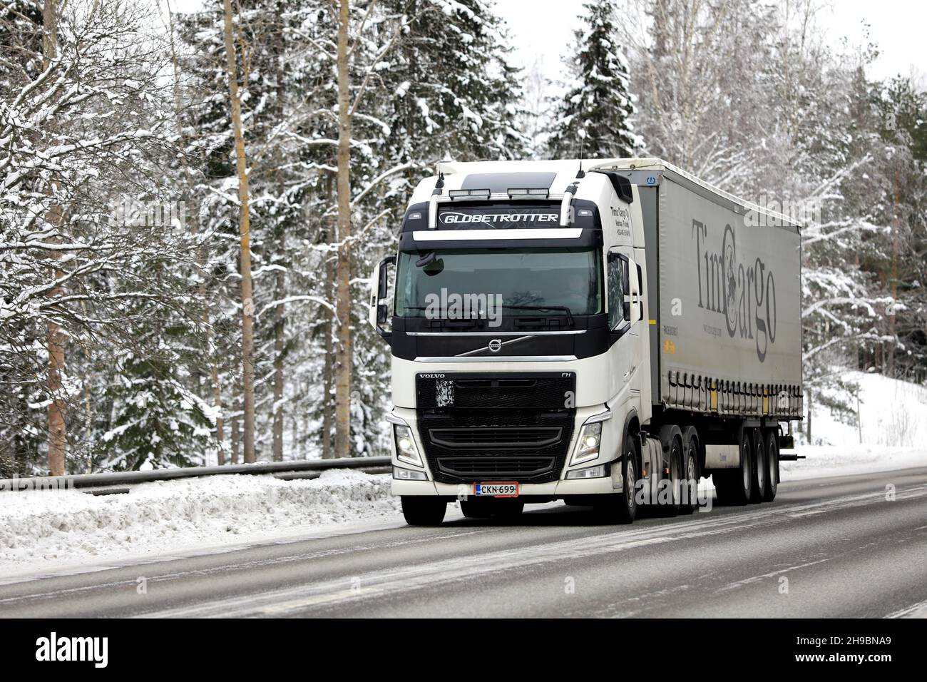 white-volvo-fh-semi-trailer-timo-cargo-oy-transporting-goods-on-highway